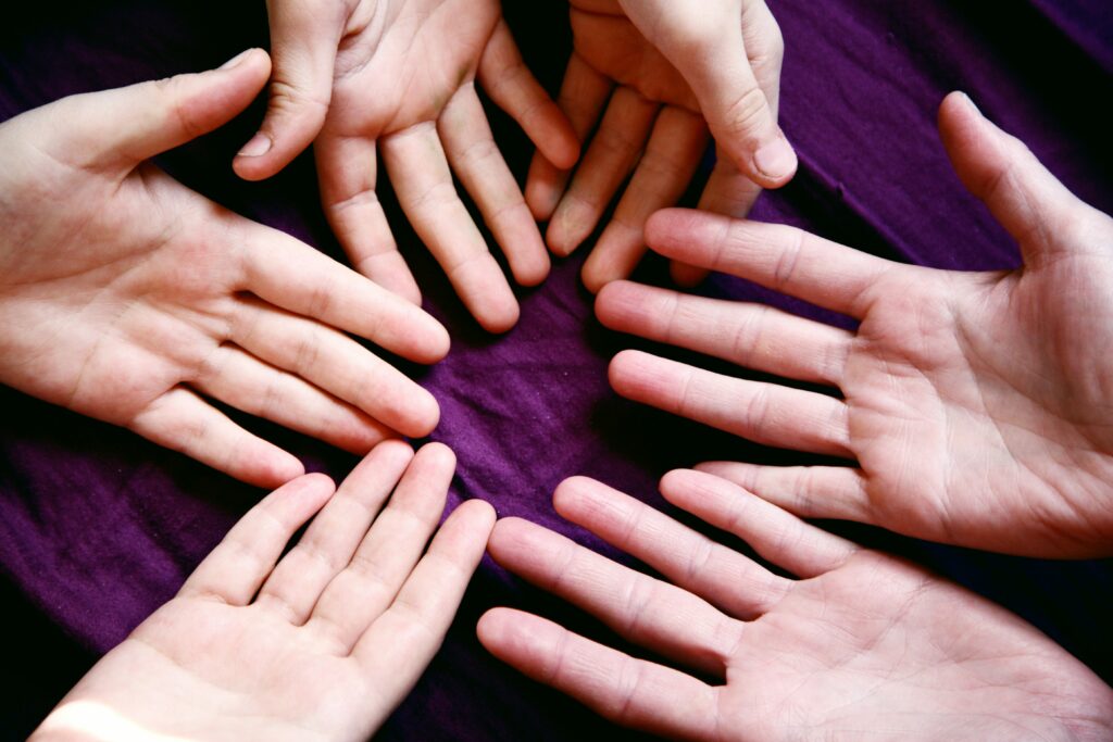 Hands holding money jar labeled ‘Caregiving Fund’