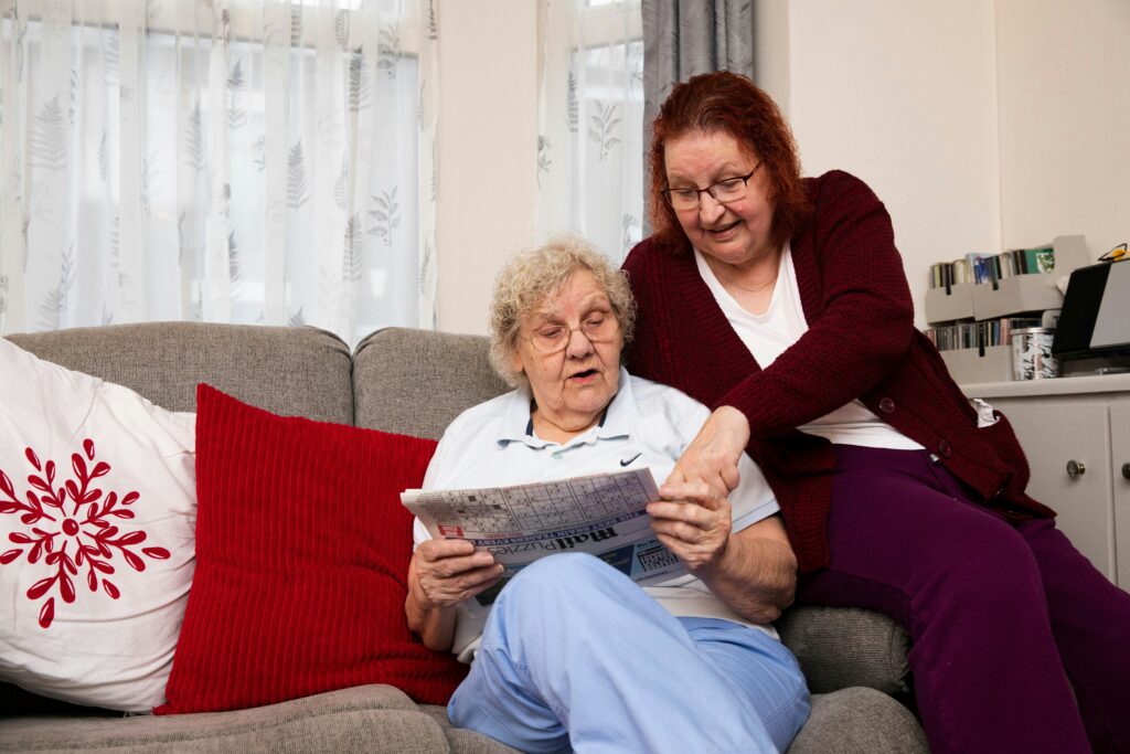 Elderly couple reviewing a home safety checklist at the kitchen table