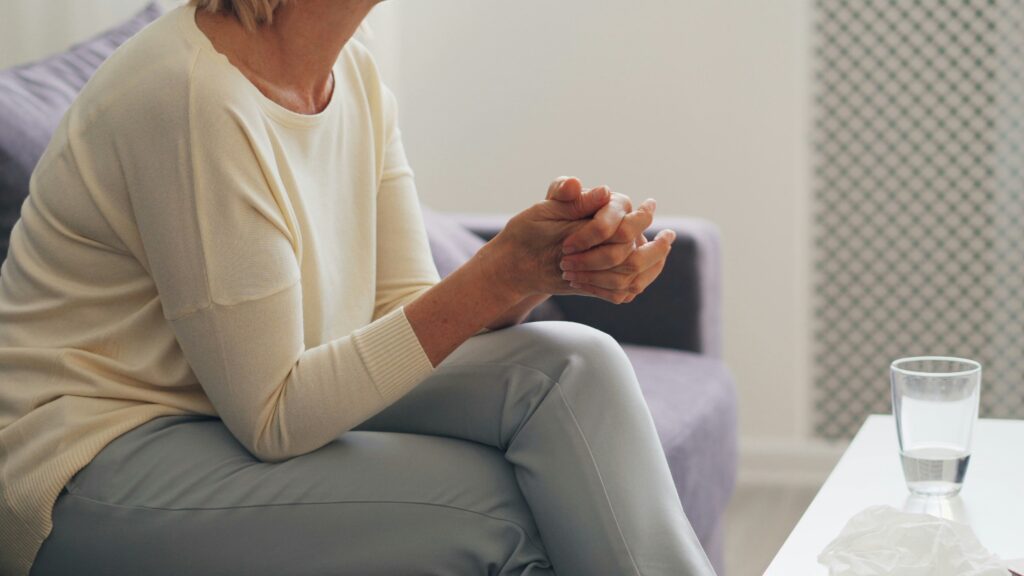 Caregiver assisting a Parkinson’s disease patient in a wheelchair.