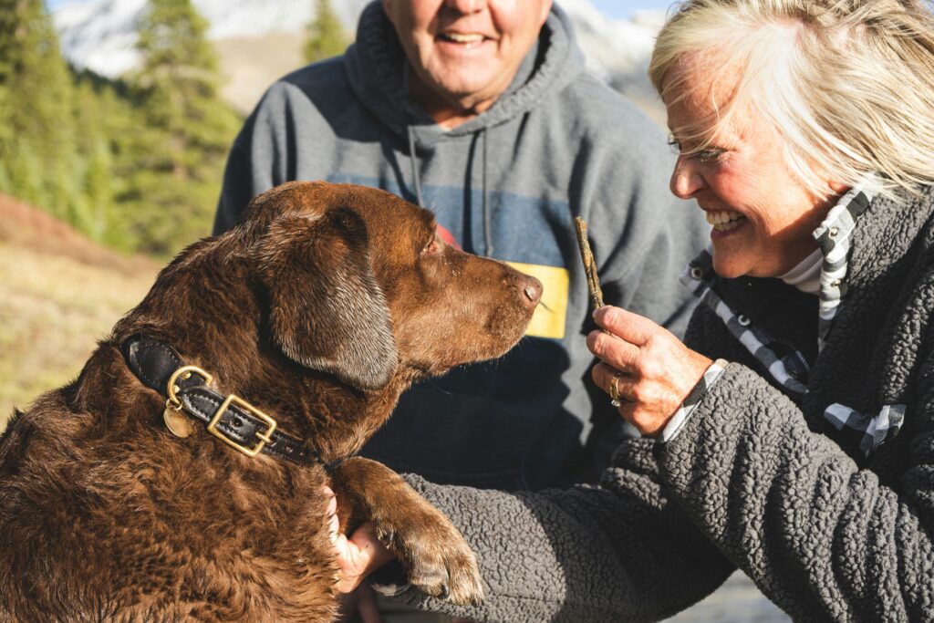 Elderly man enjoying pet therapy while petting his therapy dog.