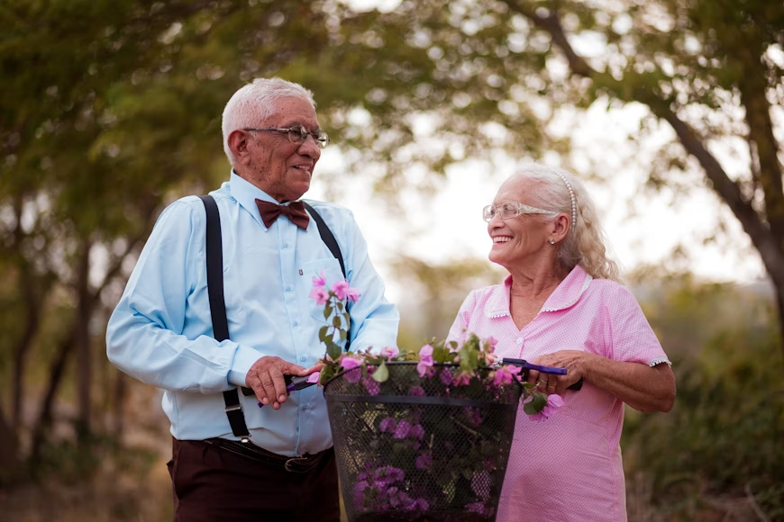 Senior couple smiling while watching a comedy show