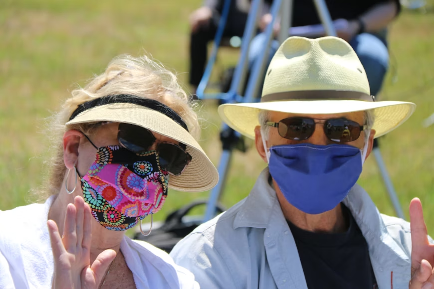 Seniors enjoying gardening and smiling outdoors