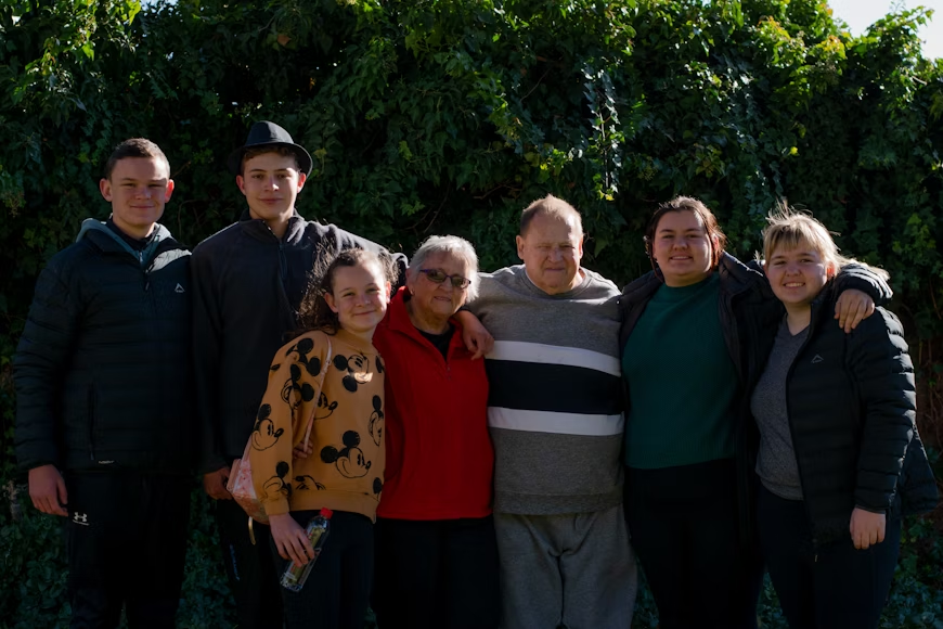 Family enjoying a picnic in the park during planned intergenerational activities