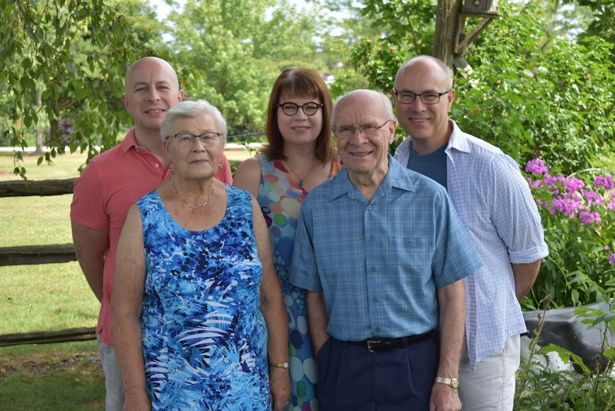 Caregiver assisting elderly man with meal preparation at home