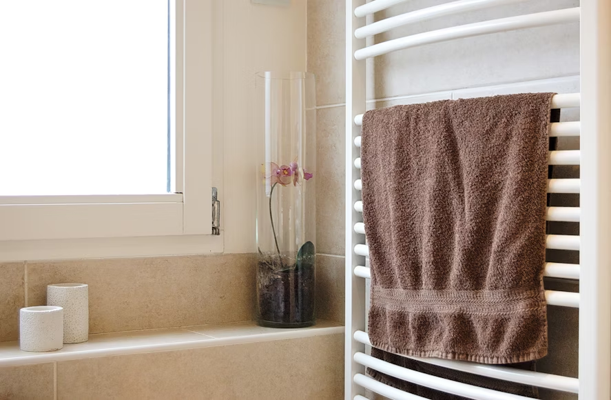 In-home bathing setup with grab bars and shower chair for safety