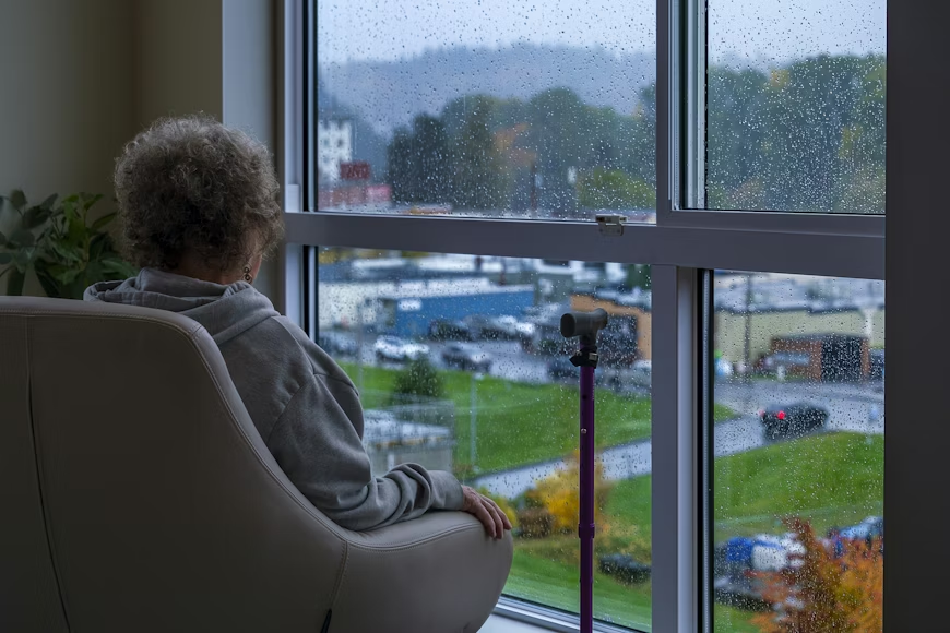 Older woman sitting in a chair doing mindfulness meditation