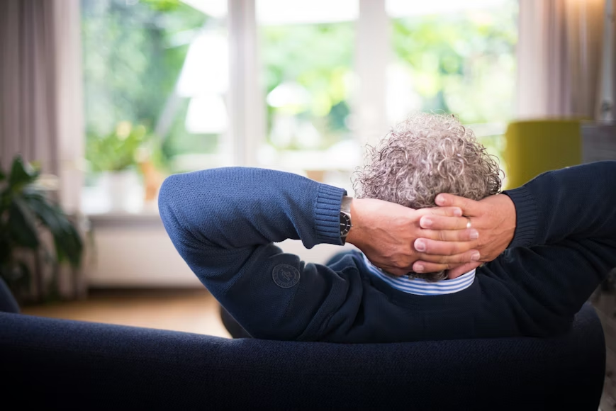 Senior couple practicing yoga together at home for emotional well-being