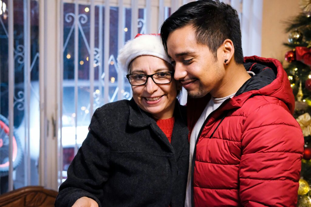 In-home care services assisting a senior with warm winter clothing indoors