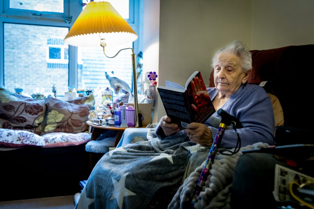 Caregiver providing in-home care services to an elderly person during winter months