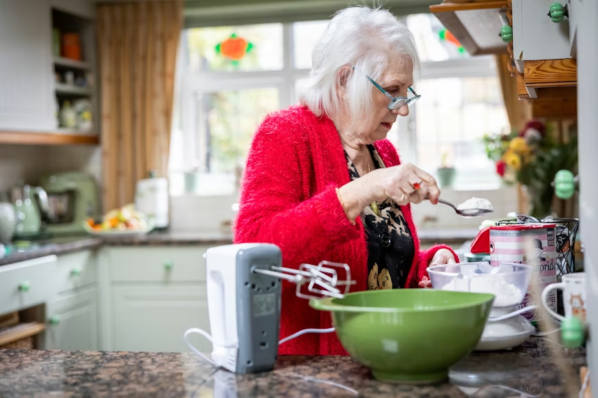 Elderly woman exercising at home to support senior new year resolutions