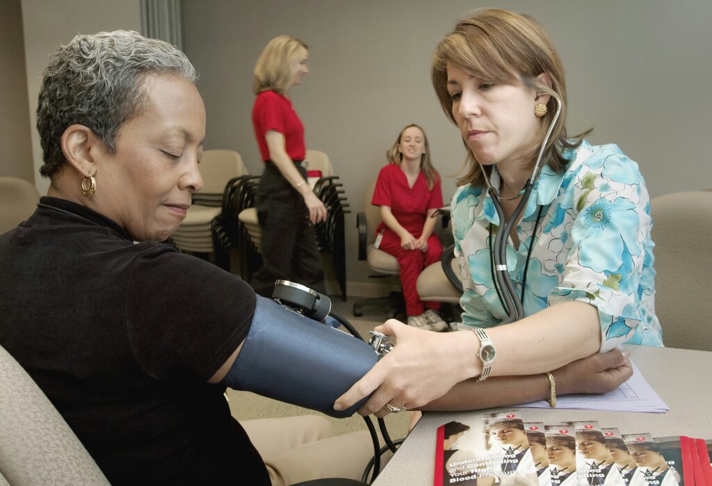 Professional in-home caregiver assisting elderly woman at home in Indiana