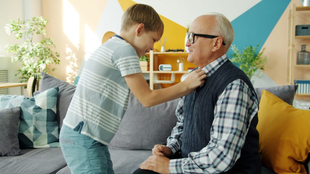 Elderly father and adult child sharing a hug on Father's Day at home