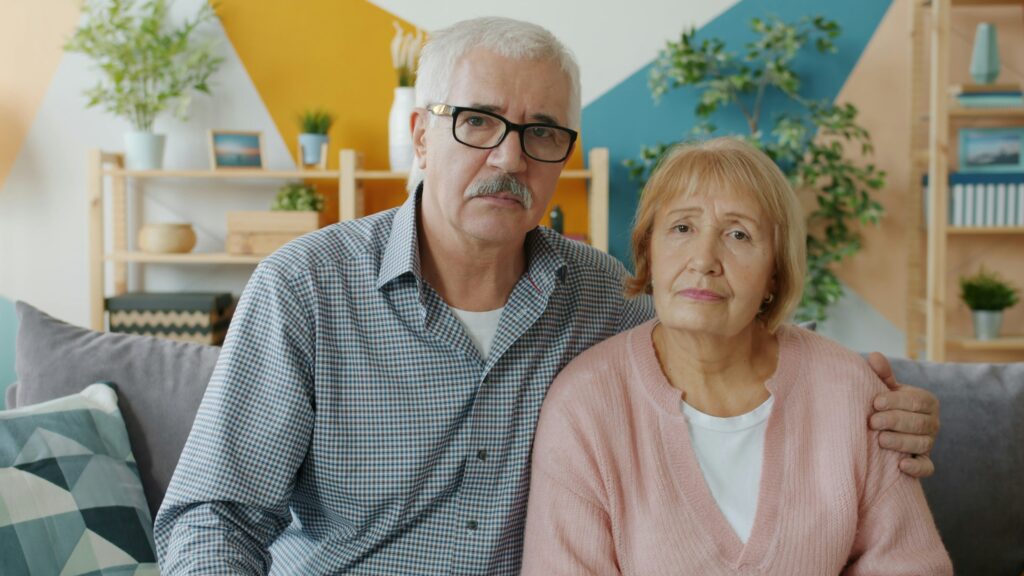 A senior couple walking together outdoors, staying active after family recognized early signs elderly parent needs help.