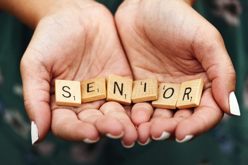Older adult receiving calm reassurance from a family caregiver