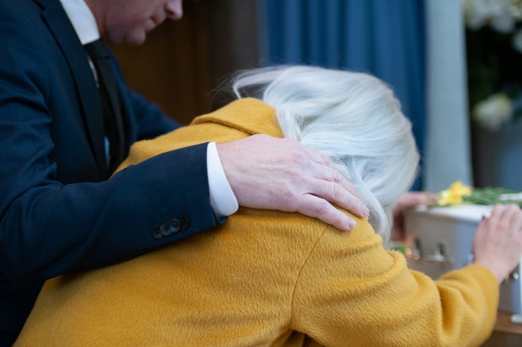 Adult daughter checking on her mother at home as part of a backup care for elderly parents plan